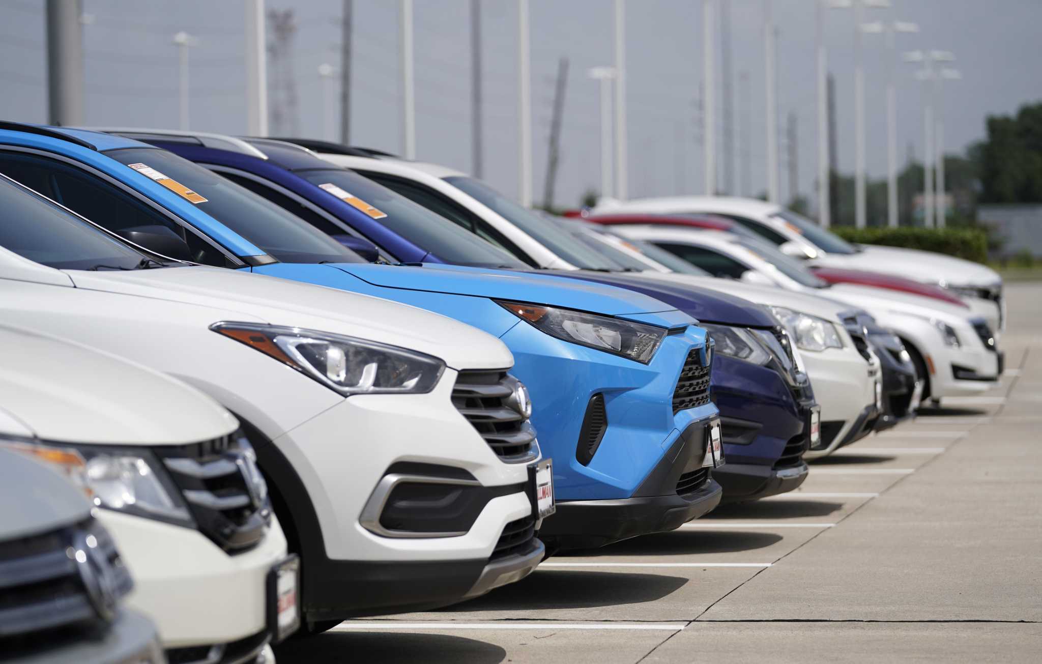 a row of cars parked in a parking lot